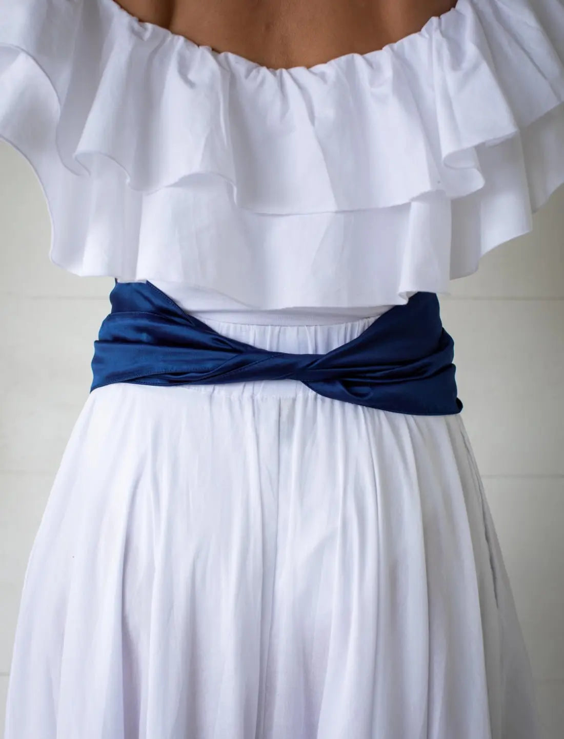 The rear view of the model wearing the Eye of Dharma Embroidered Belt. Here, the belt is shown where it ties in the front. You can also tie it into a neat bow in the back.